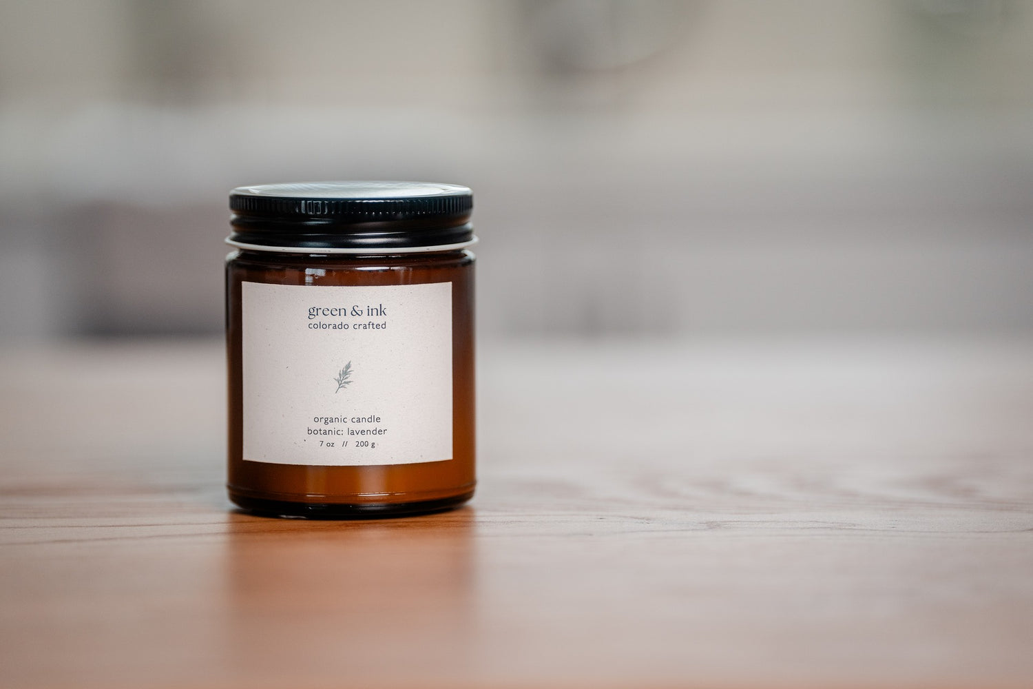 Organic candle in an amber jar with white label &