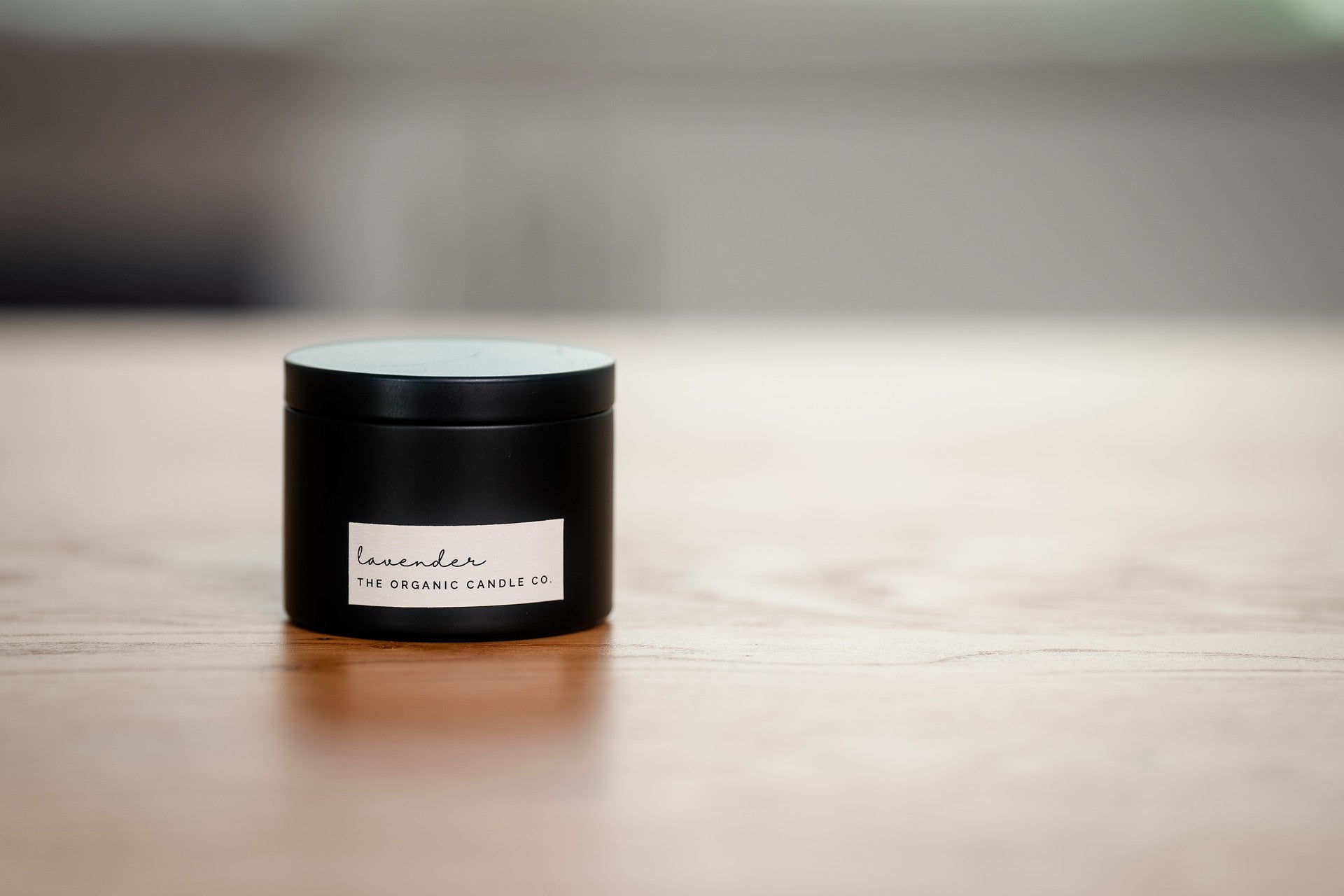 Black metal organic candle on a wooden kitchen surface