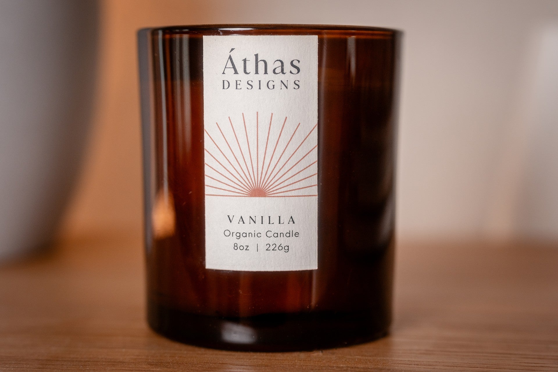 Modern amber organic candle with a white label showing &