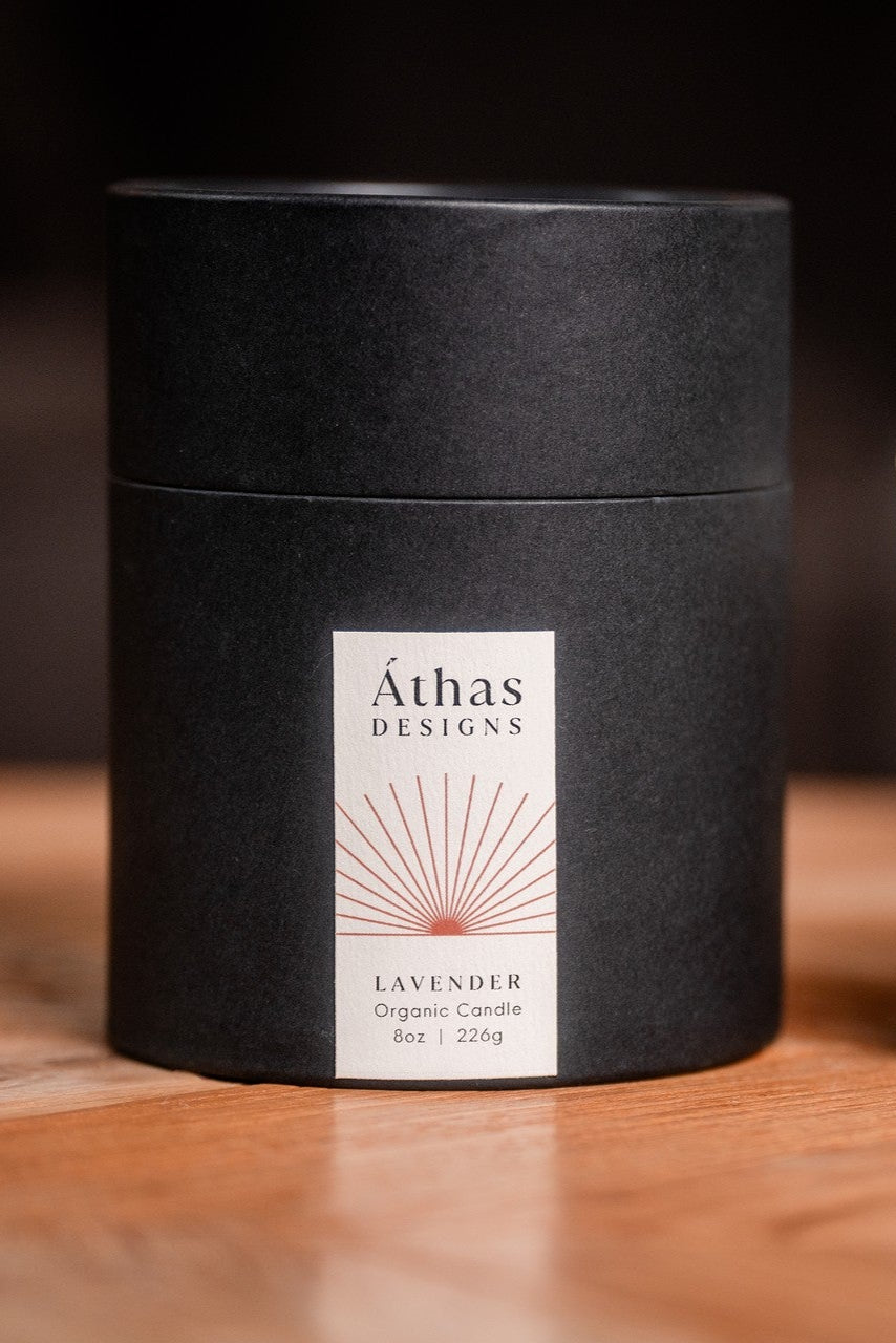 Áthas Designs organic candle and packaging on a wooden surface