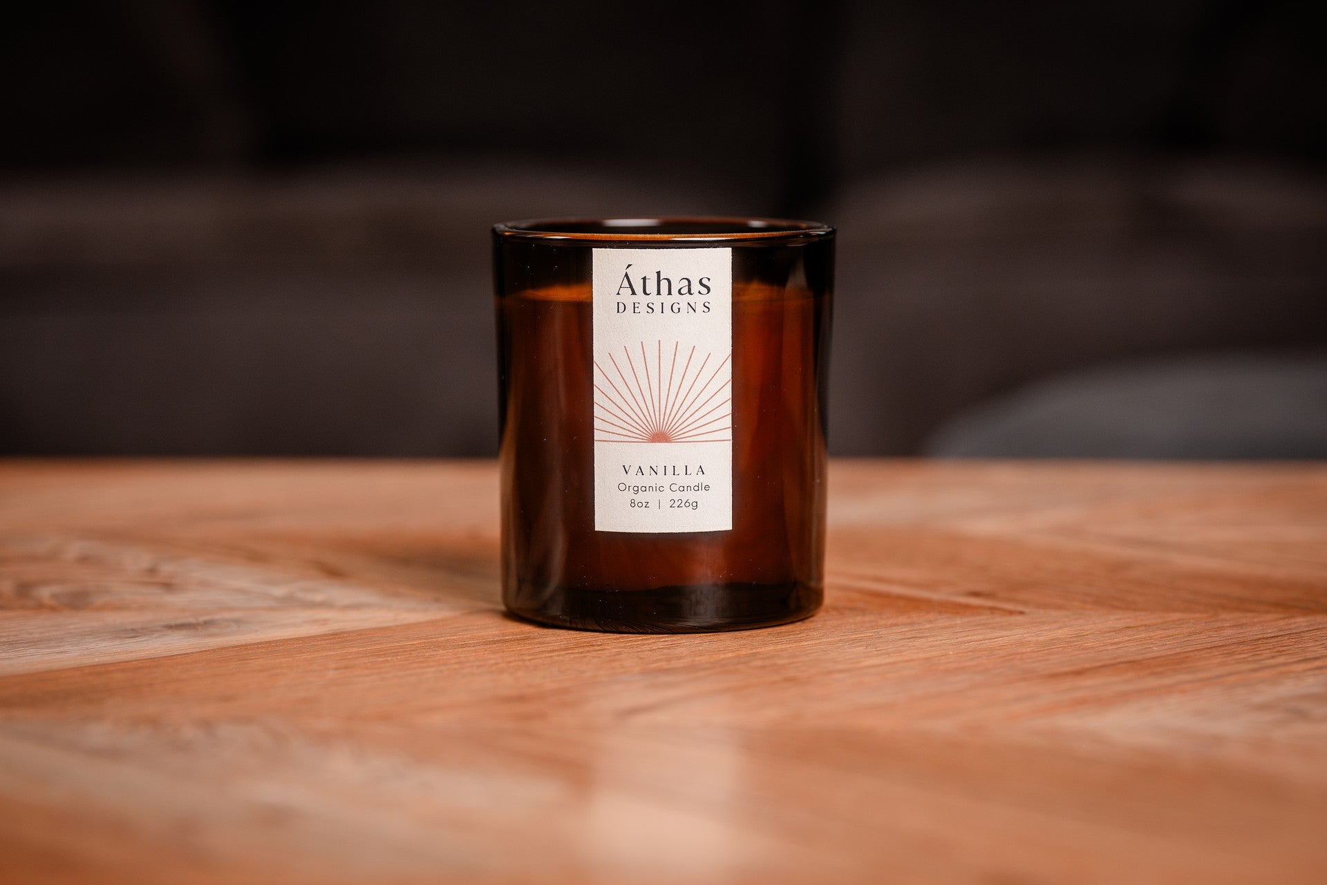 Modern amber organic candle with a white label showing &