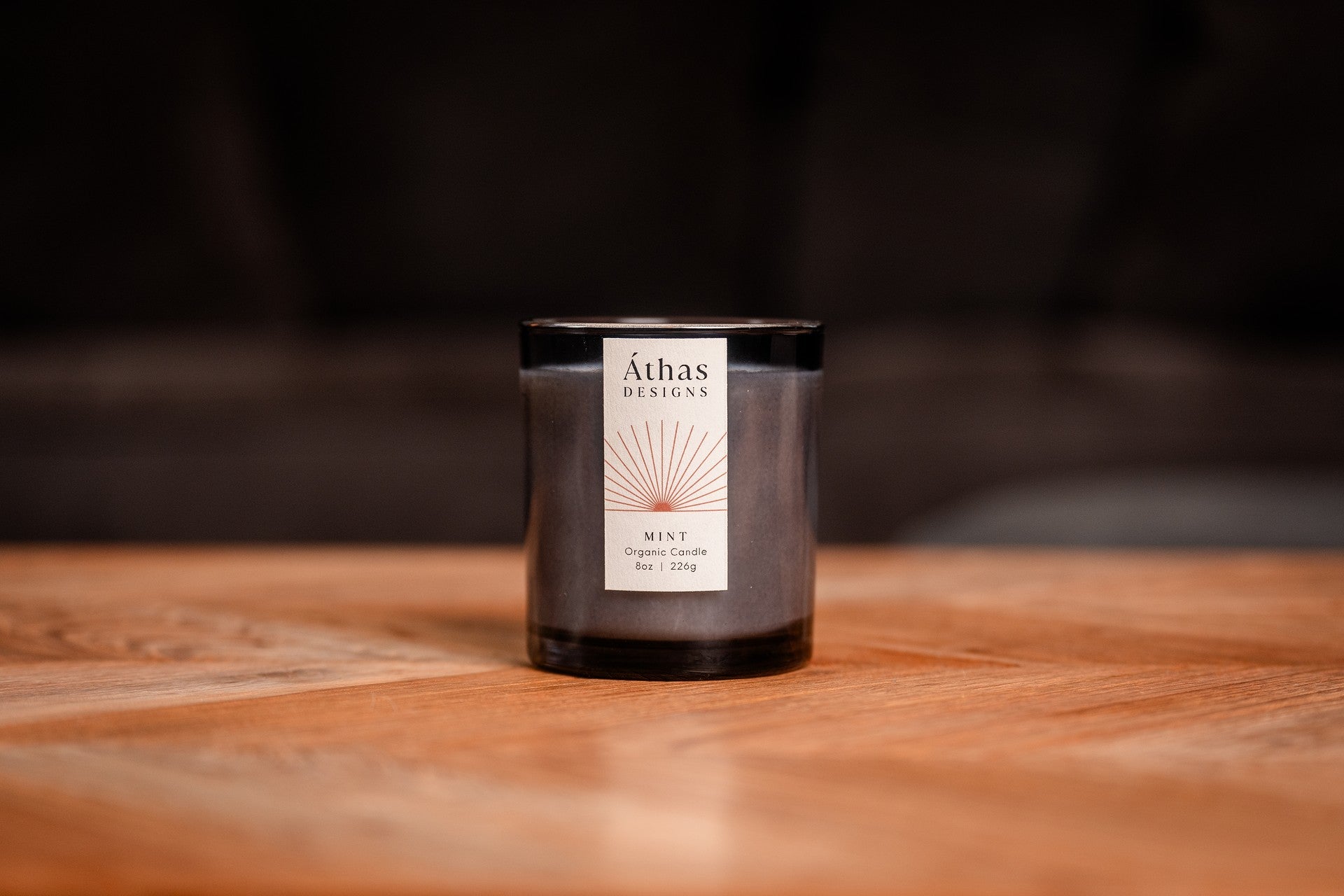 Organic candle in modern dark blue glass container with &