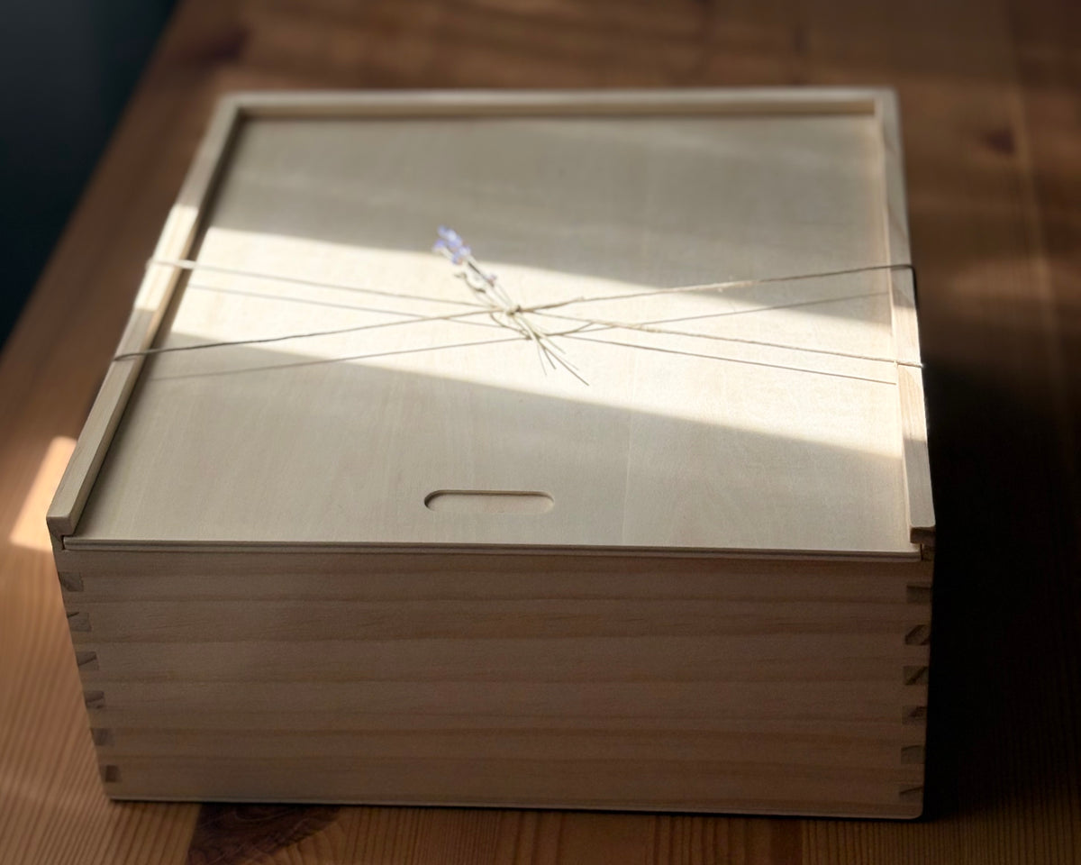 Wooden box with a lid on a wooden surface