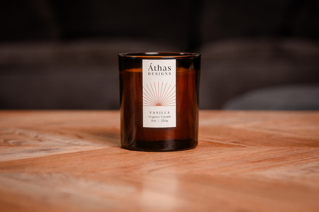 Modern amber organic candle with a white label showing &