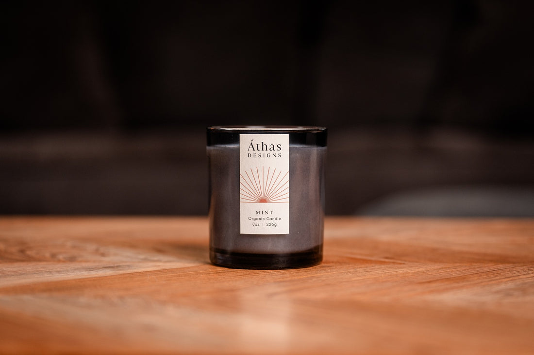 Organic candle in modern dark blue glass container with &