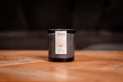 Organic candle in modern dark blue glass container with &