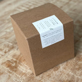 Brown cardboard box with a white label on a wooden surface