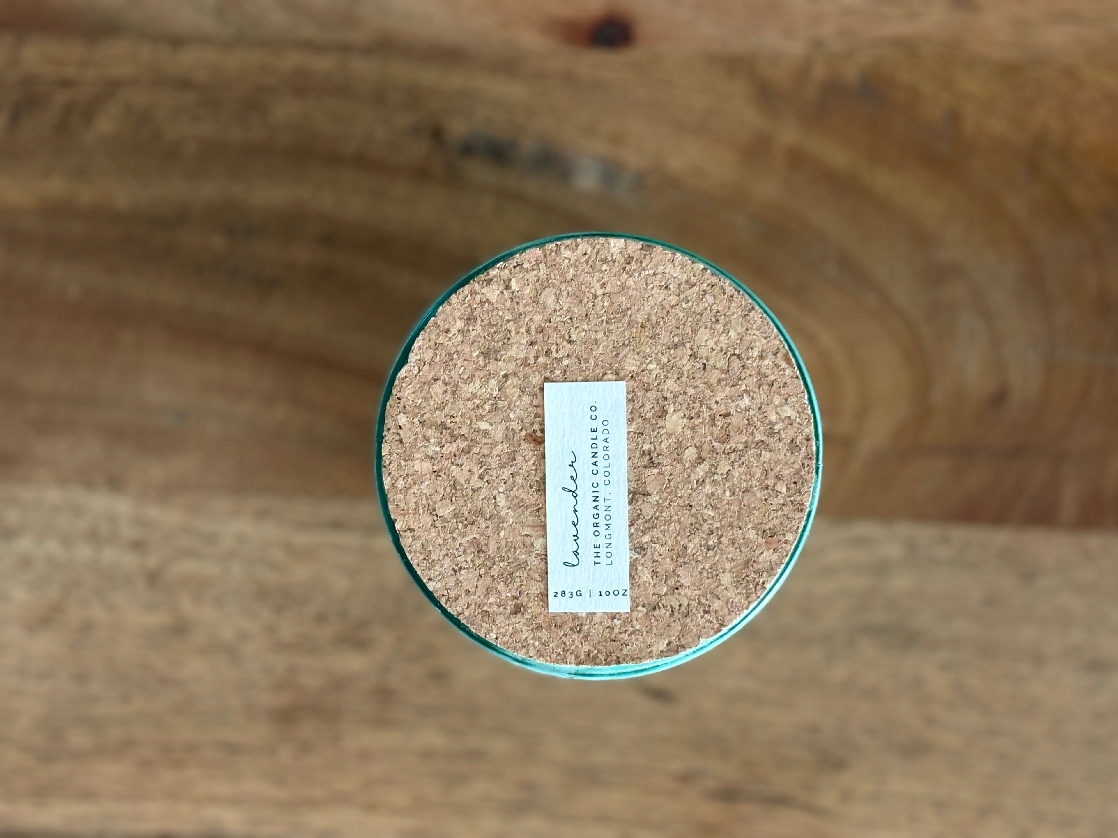 Cork lid with a label on a wooden background