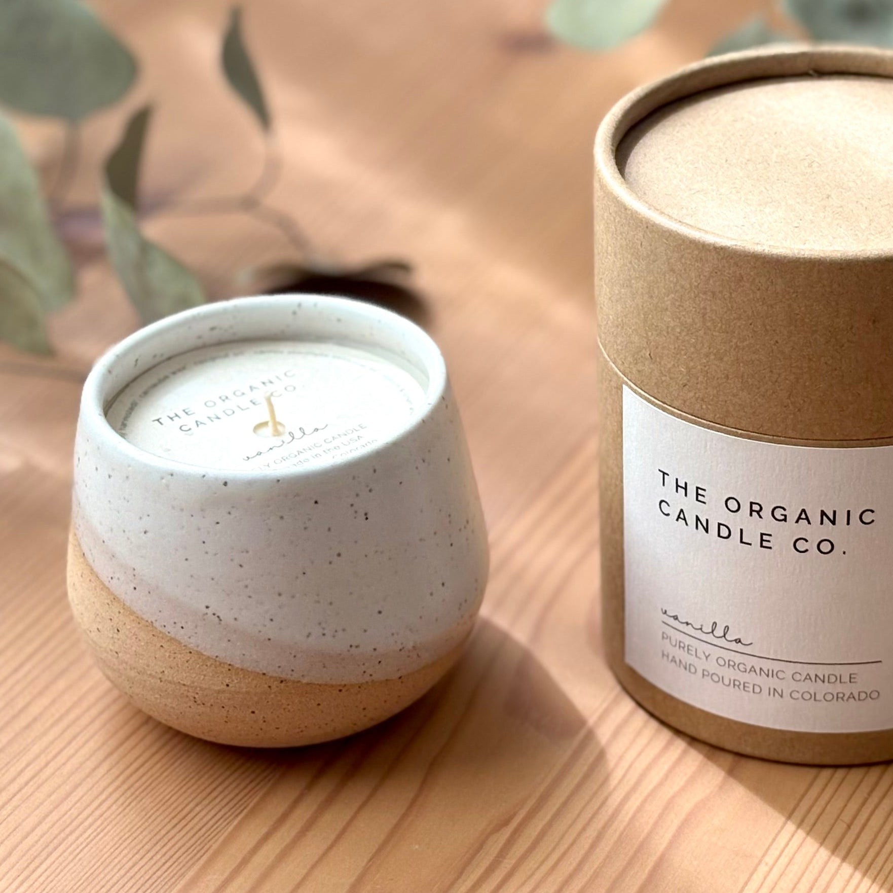 Ceramic organic candle in a white container with &