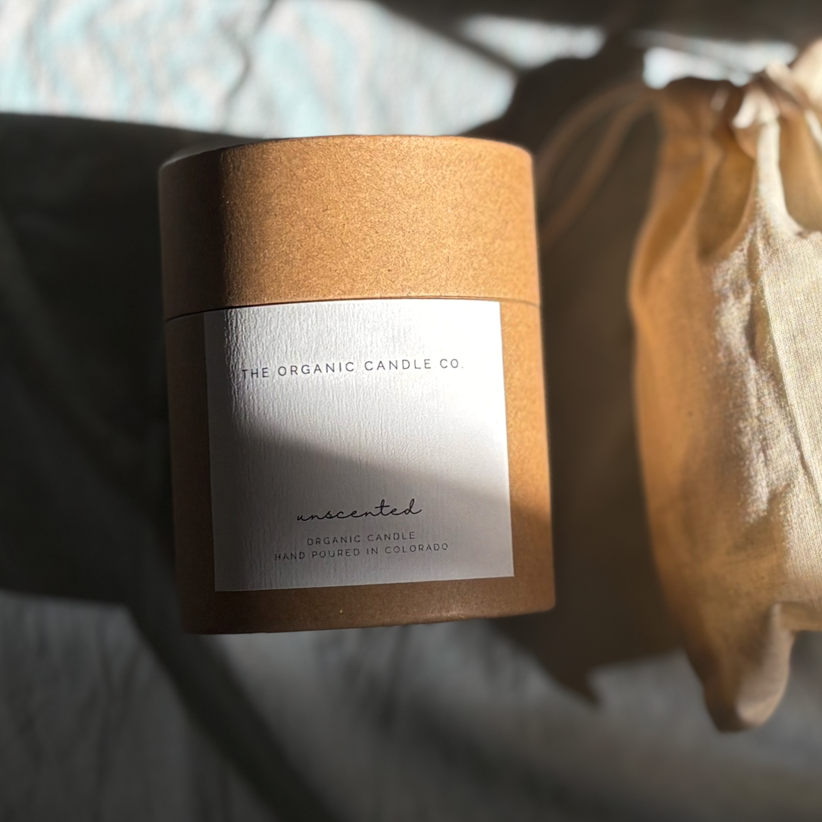 A kraft paper jar candle with a white label reading &
